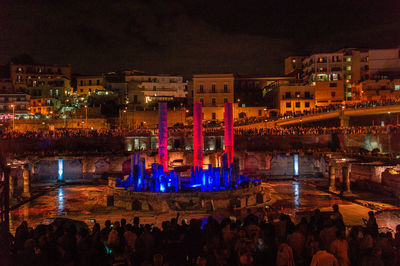 High angle view of illuminated city buildings at night