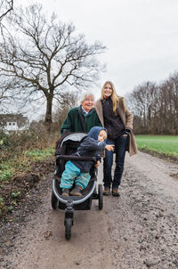 Happy family with baby on dirt road