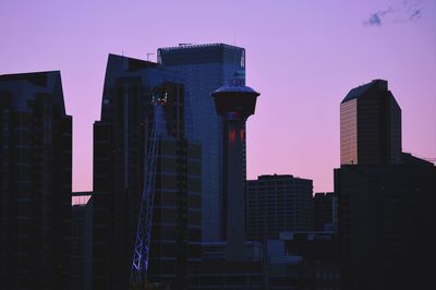 Low angle view of skyscrapers against sky during sunset