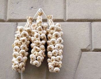 Low angle view of garlic bulbs hanging on wall