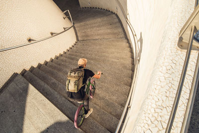 High angle view of man riding bicycle on staircase