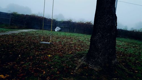 Wet golf course against sky during rainy season