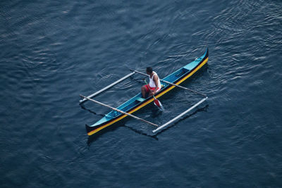 High angle view of man sitting in sea