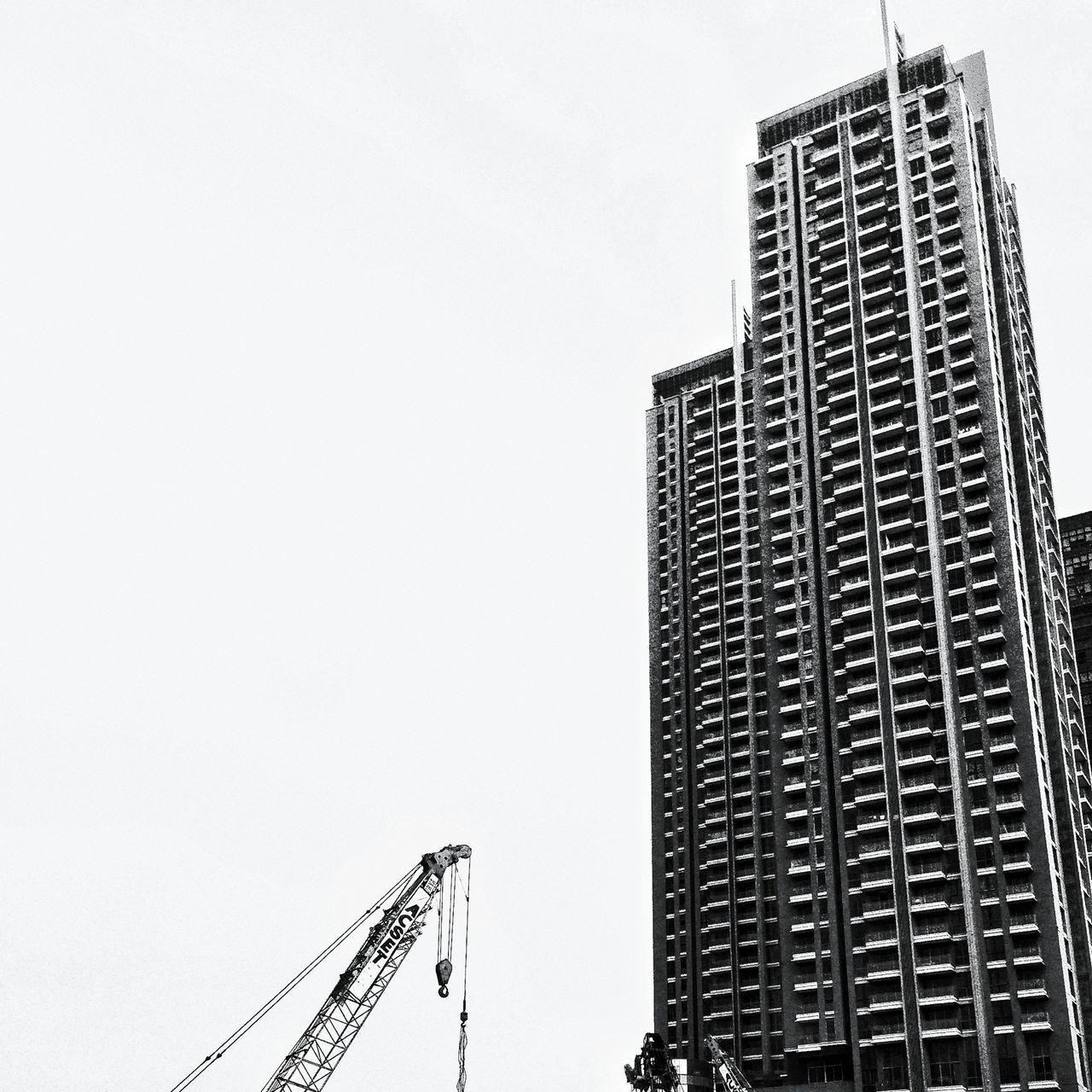 architecture, building exterior, built structure, clear sky, low angle view, development, tall - high, construction site, copy space, crane - construction machinery, construction, city, skyscraper, tower, incomplete, tall, crane, modern, building, office building