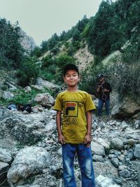 Portrait of boy standing on rock