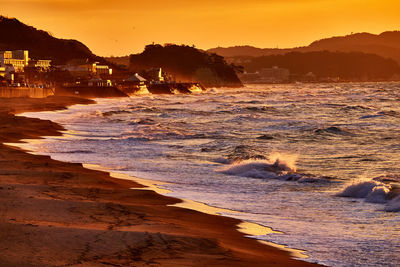 Scenic view of beach against sky during sunset