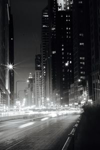 Illuminated city street at night