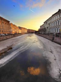 Buildings in city at sunset