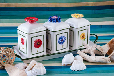 Seashells and containers on table