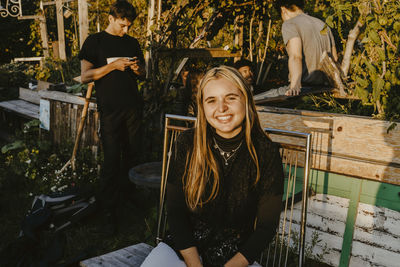 Portrait of a smiling girl sitting outdoors