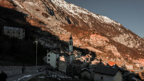 View of old town by mountain against clear sky