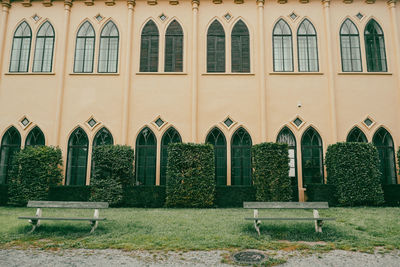 Empty chairs outside house against building