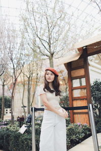 Young woman wearing flat cap while standing in park