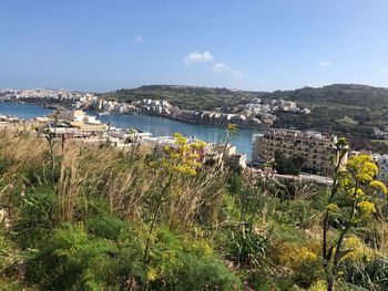 High angle view of buildings and sea against sky