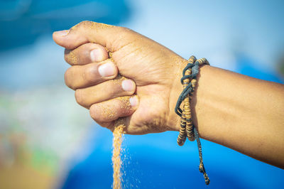 Close-up of hand holding rope