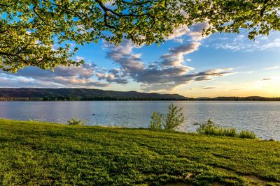 Scenic view of lake against sky during sunset