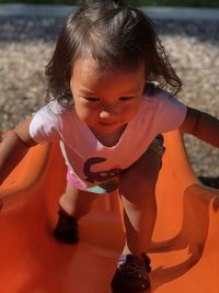 High angle view of cute girl walking on slide