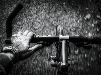 Human hand riding by bicycle