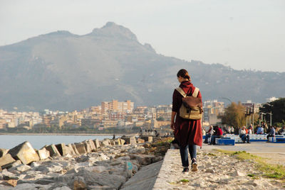 Full length of man standing on mountain against sky