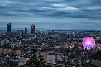 High angle view of cityscape against cloudy sky during sunset