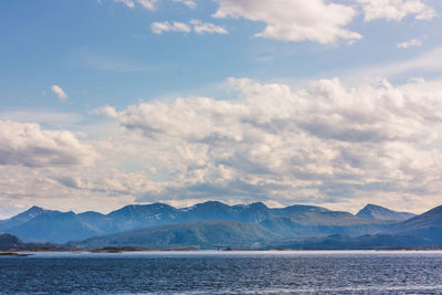 Scenic shot of calm sea against mountain range