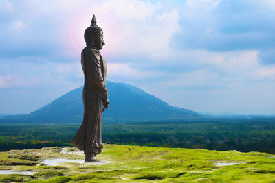 View of man standing on field against sky
