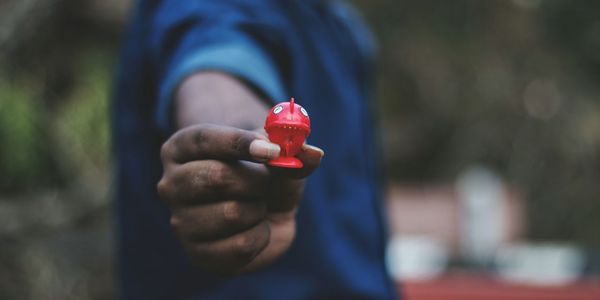 Midsection of man holding toy