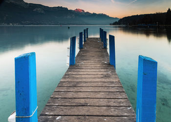 Wooden pier over lake against sky