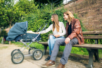 Woman sitting on bench in park