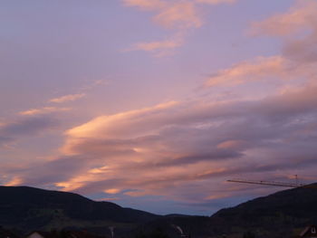 Low angle view of silhouette mountains against sky at sunset