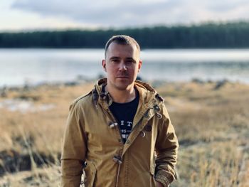 Portrait of young man standing on land