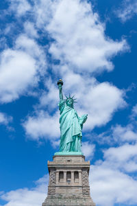 Statue of liberty against cloudy sky