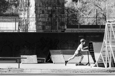 Side view of man running against building