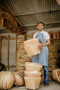 Portrait of man standing in wicker basket