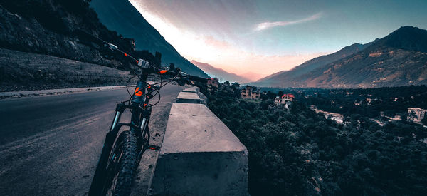 Road by mountains against sky