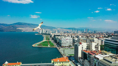 High angle view of city by buildings against sky