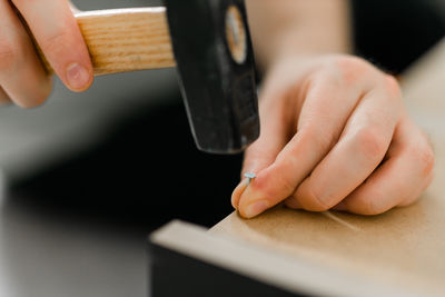 Cropped hand of person working on wood