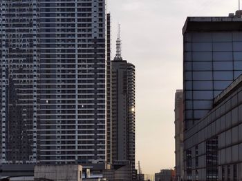 Low angle view of modern buildings in city against sky