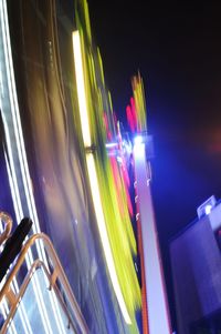 Low angle view of light trails on road at night