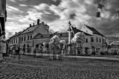 Buildings against cloudy sky