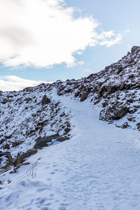 Scenic view of snow covered mountains against sky