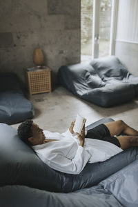 Man reading book in living room