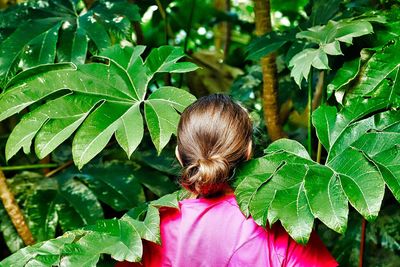 Rear view of woman with leaves