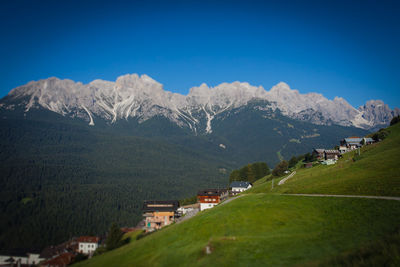 Scenic view of mountains against blue sky