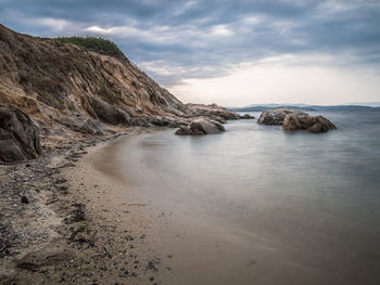 Scenic view of sea and mountains against sky