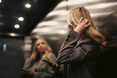 Young woman looking away in elevator