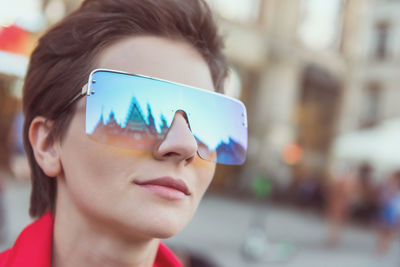 Close-up portrait of woman wearing sunglasses