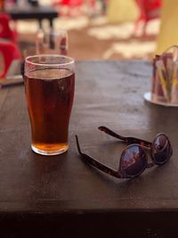 Close-up of beer and sunglasses on table