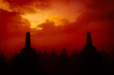 Silhouette temple against sky during sunset