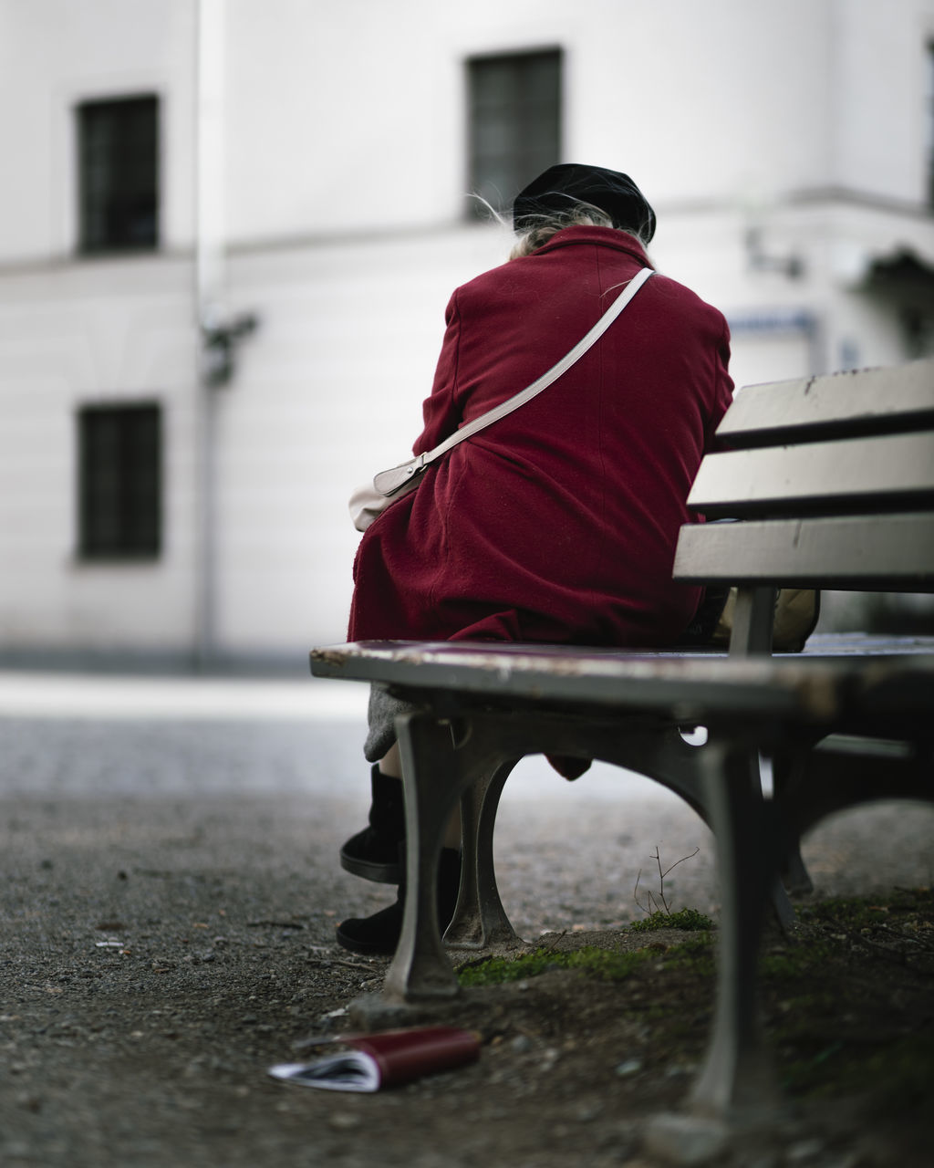 REAR VIEW OF MAN SITTING ON BENCH